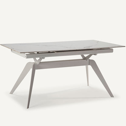 Mesa comedor Lula, rectangular y extensible, en color blanco con pie metálico blanco. Fabricada de cerámica y metal.