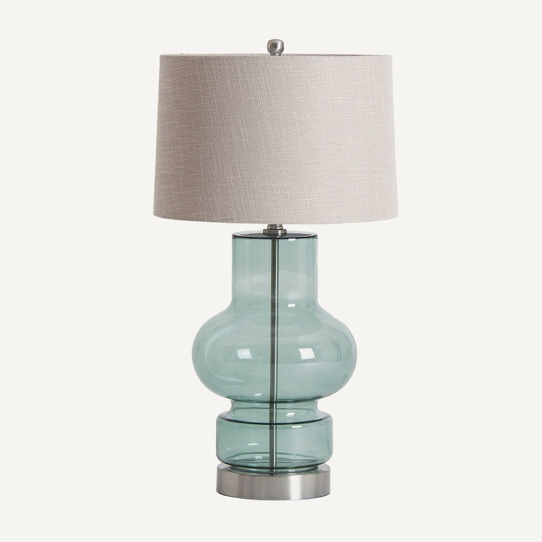 Lámpara de mesa estilo clásico color gris azulado, fabricada de vidrio, hierro y lino.